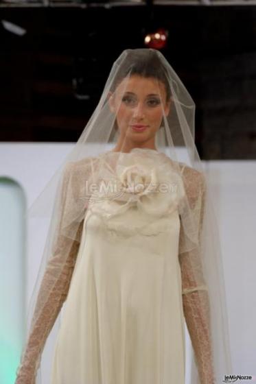 Vestito da sposa con velo impalpabile e applicazione di rose